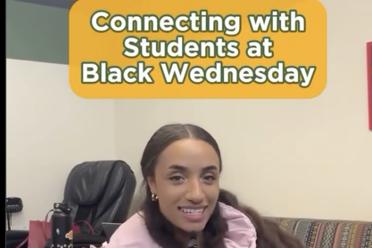 rachel sitting on a chair talking into a microphone