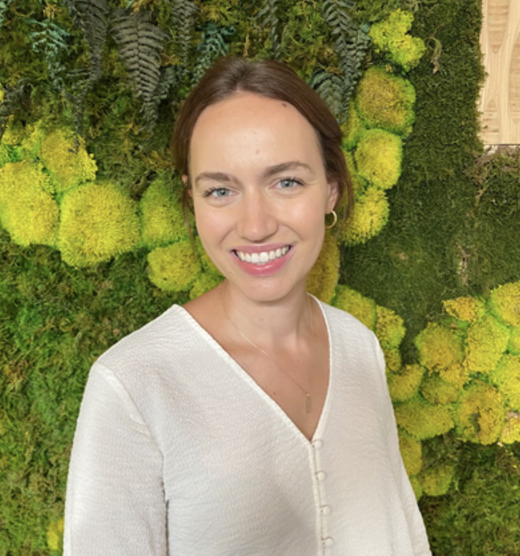 Headshot of Anns Hilke with her hair pulled into an updo wearing a white blouse.