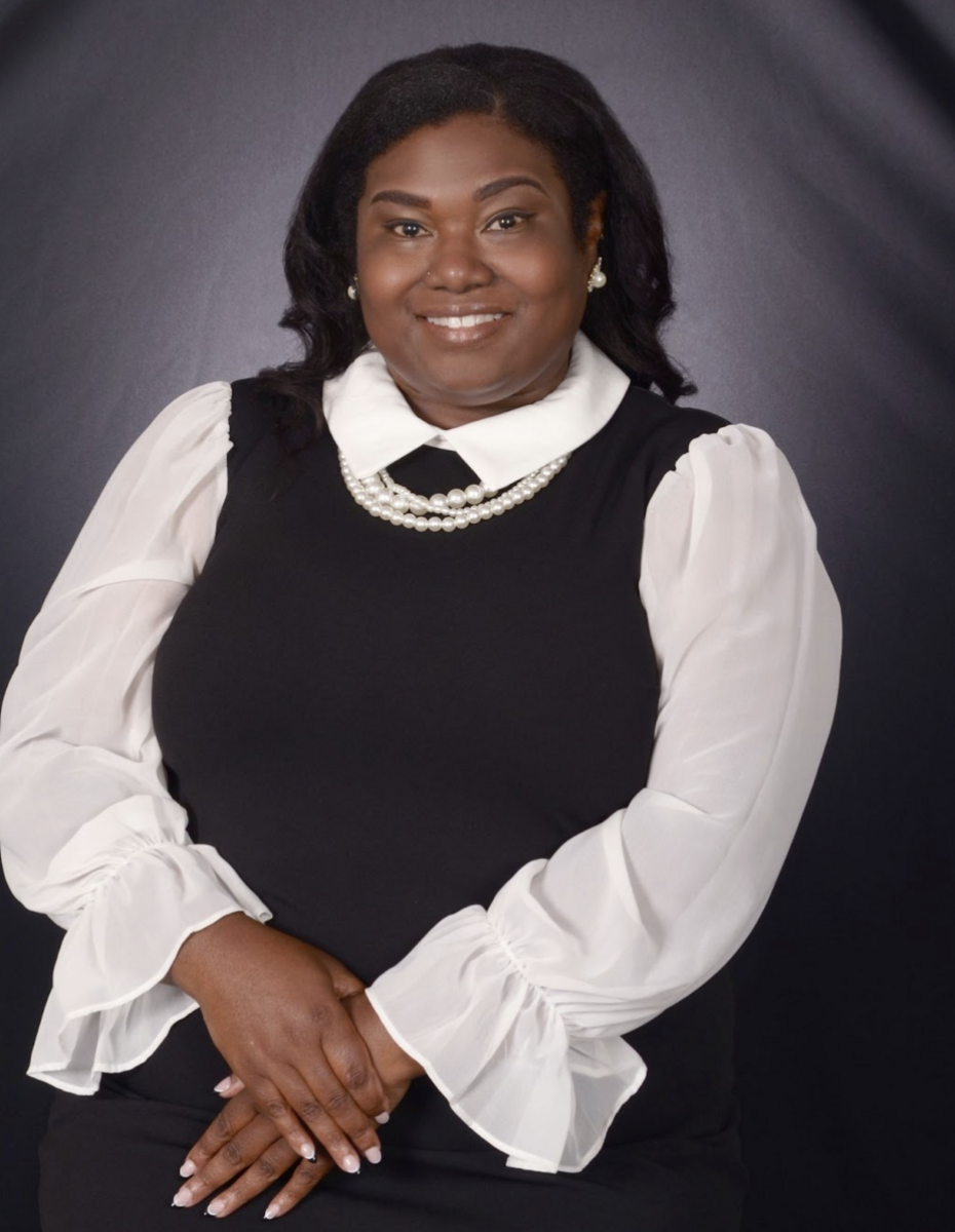 Lez'li Waller wearing a black vest with a white long sleeve underneath.