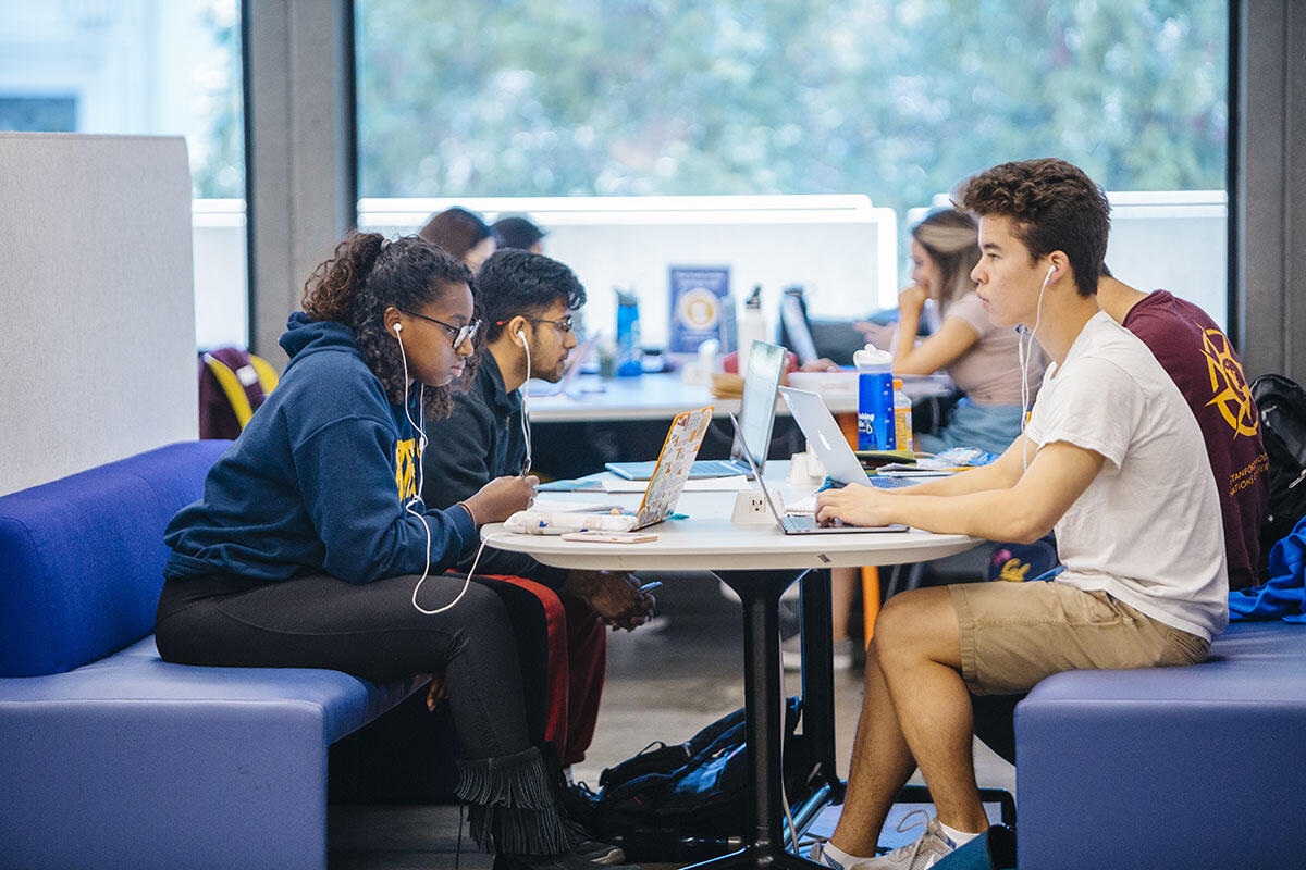 Students studying together at a table in Moffitt Library.
