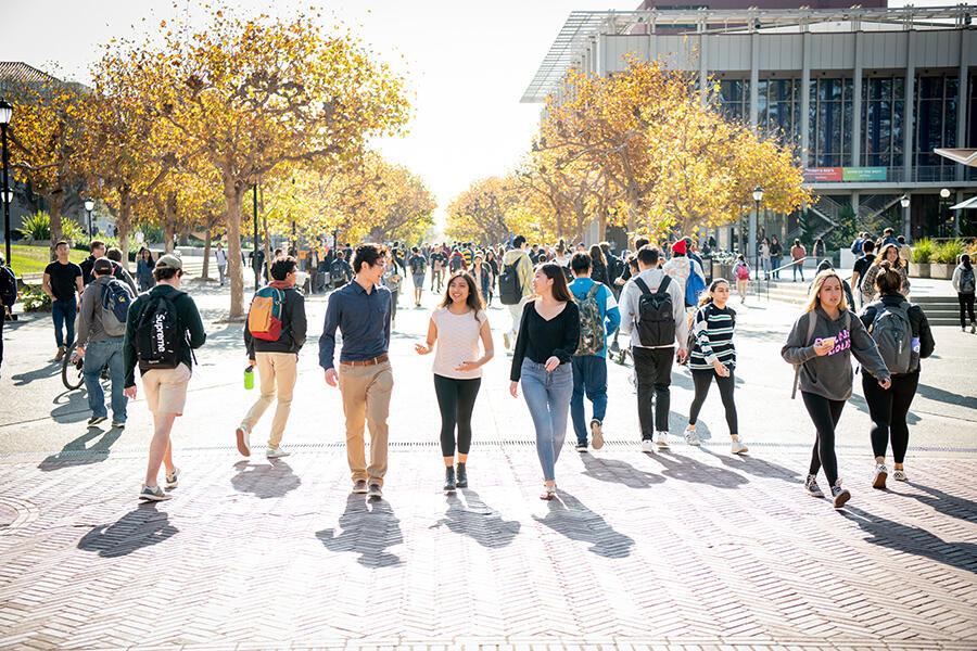 3 students walking underneath the sproul