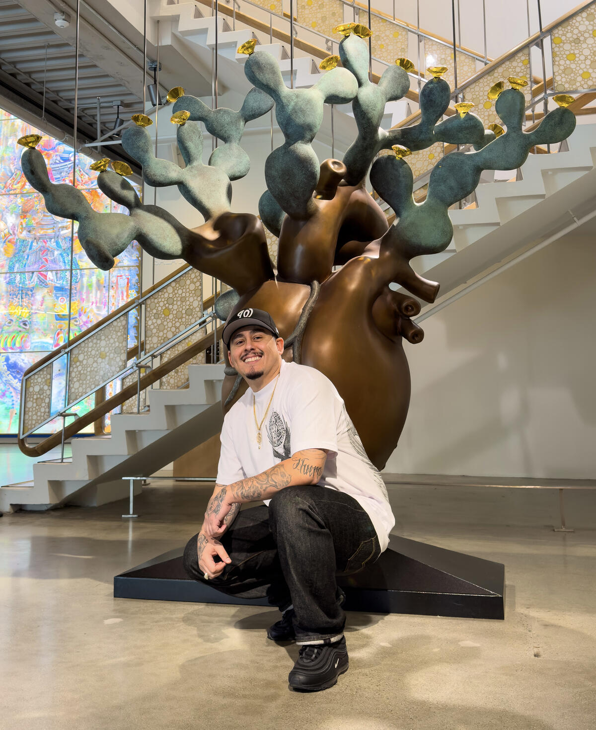 Photo of Michael Cerda-Jara in front of a sculpture