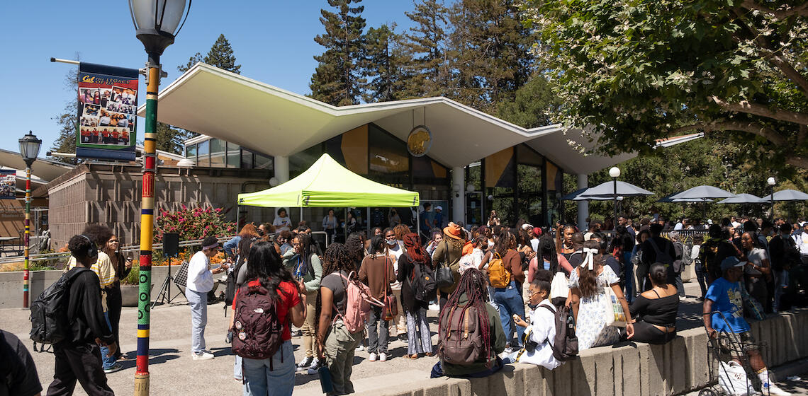 Students mingling in front of Golden Bear Cafe on a sunny day