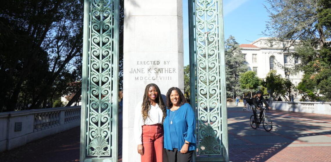 Two Black women smiling in front of Sather Gate
