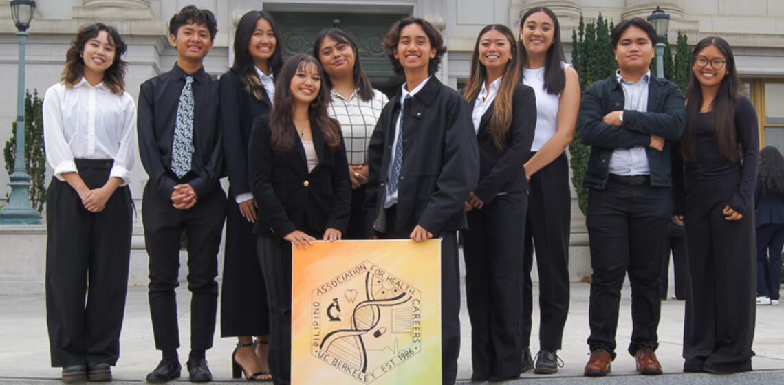 students in front of doe library steps that are part of Pilipino Association for Health Careers (PAHC) Org